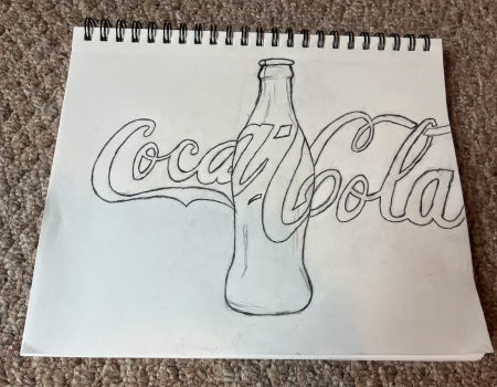 A drawing of the coca-cola logo in a sketchbook